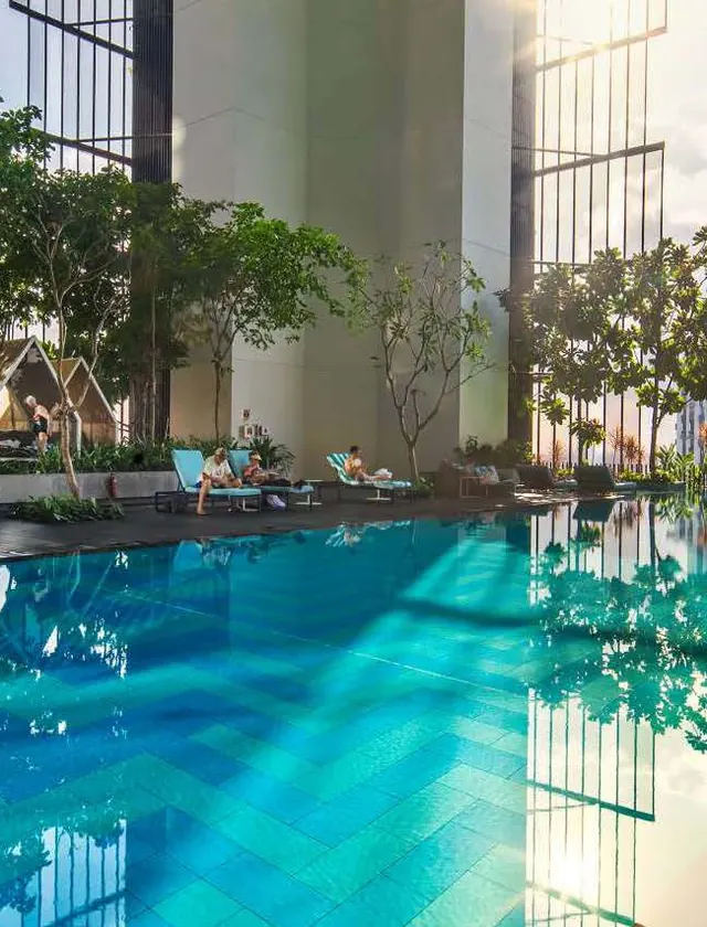 Rooftop infinity pool surrounded by greenery